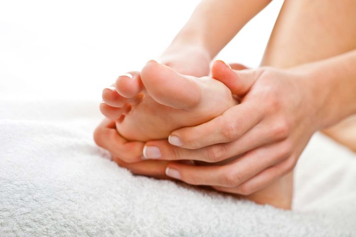 Woman rubbing her foot.