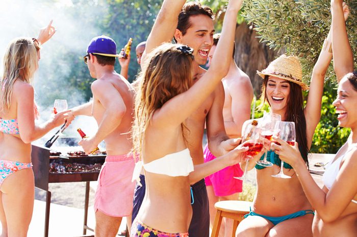 young people with drinks at a pool party