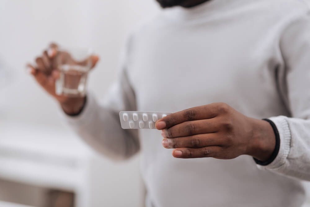 Selective focus of medicine being in hands of a nice adult man